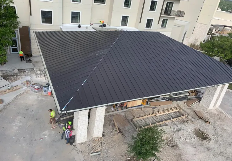 Metal roofing installation team working on a commercial building in Oxford